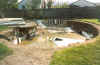 The pool after we was done smashing up the concrete, waiting fer the big tractor to fill it in